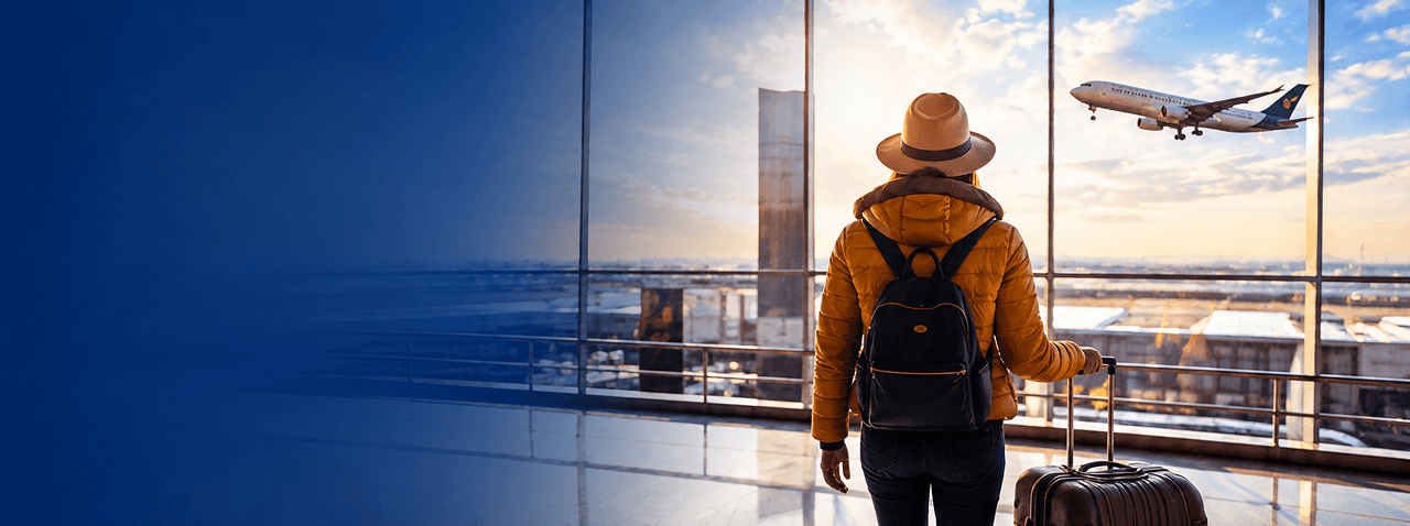 Traveler standing at an airport with a plane outside